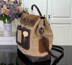 Tan and dark brown shoulder handbag with top handles, front flap pockets and buckles