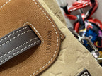 Louis Vuitton embossed leather tab with LV pattern and white contrast stitching, tan.