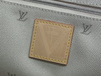Gray fabric interior pocket with stitched rectangular Louis Vuitton leather patch