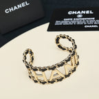 Gold-tone chain bracelet with CHANEL letter design and black enamel accents