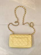 Chanel quilted shoulder bag with gold chain strap and front flap logo clasp