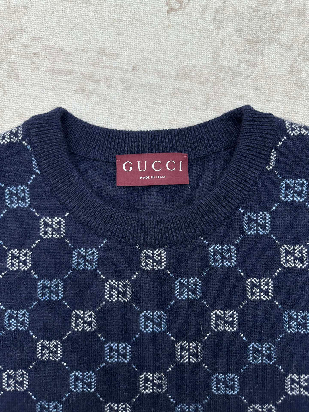 Navy crewneck sweater with GG monogram knit pattern at the chest
