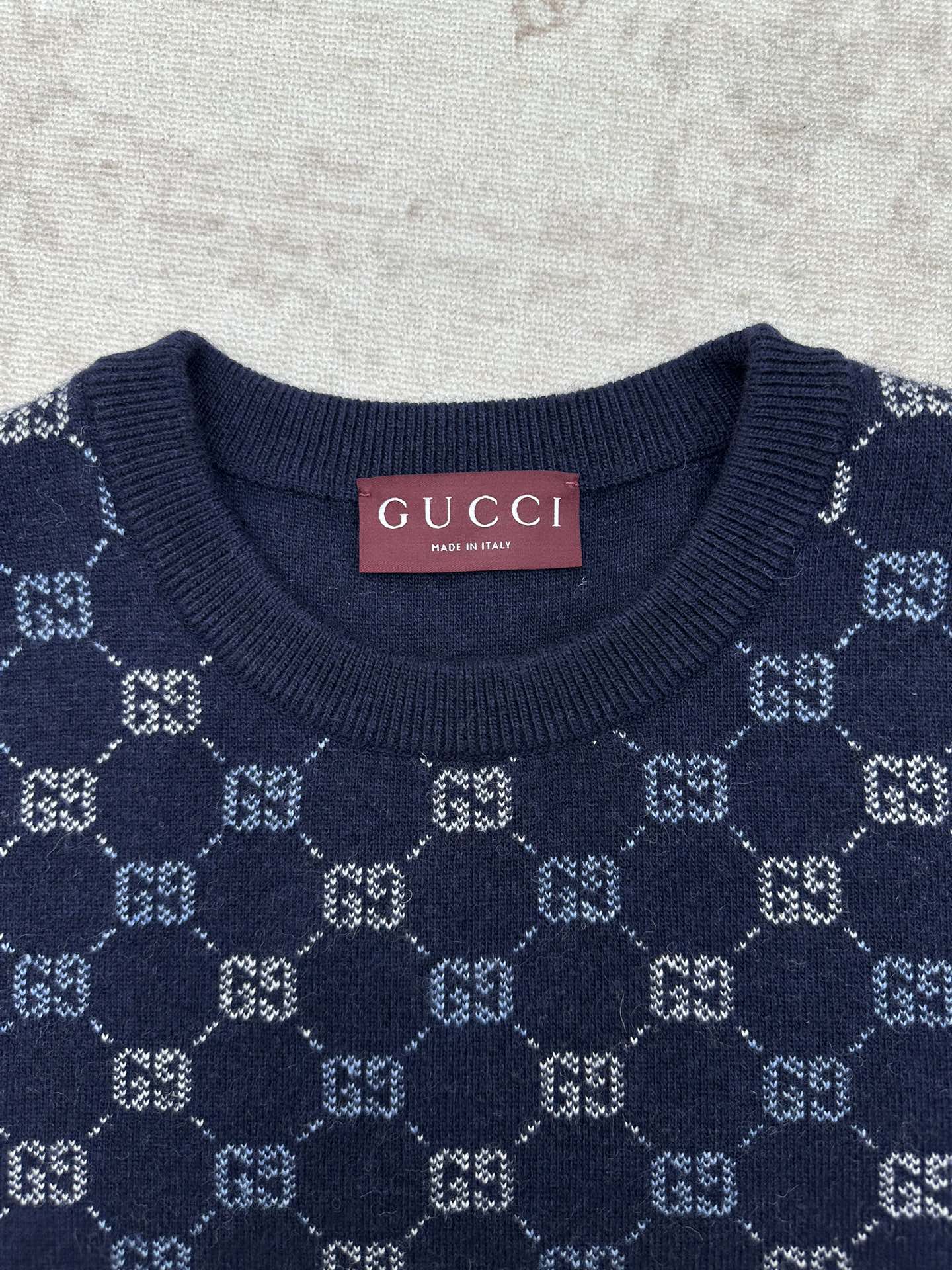 Navy crewneck sweater with GG monogram knit pattern at the chest