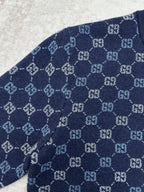 Navy long-sleeve sweater with allover GG monogram knit pattern on the sleeve