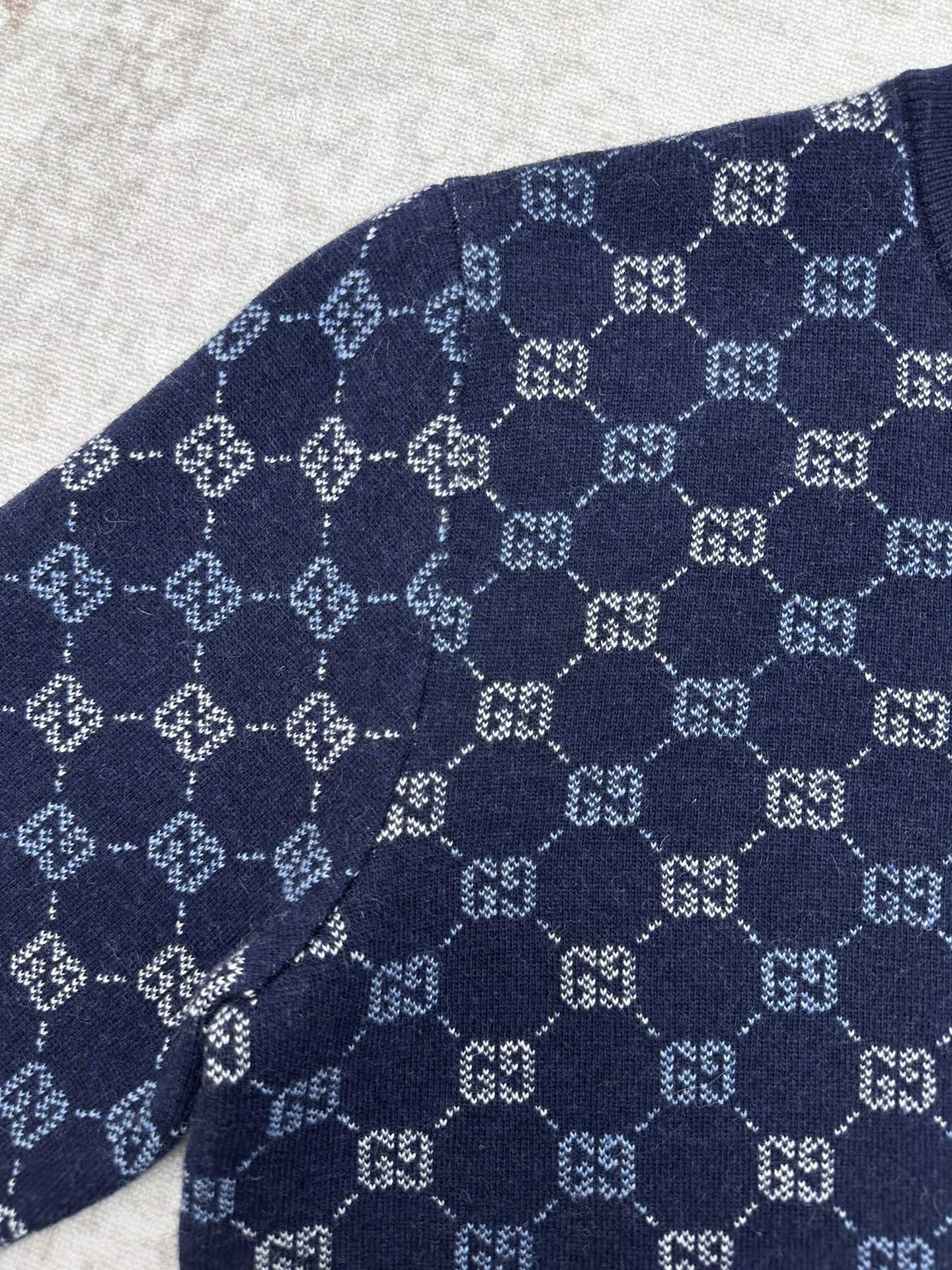 Navy long-sleeve sweater with allover GG monogram knit pattern on the sleeve