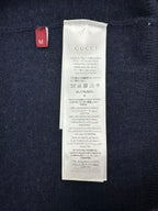 Size label and care tag inside a navy GG monogram knit sweater