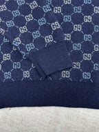 Navy long-sleeve sweater with GG monogram knit pattern and ribbed collar