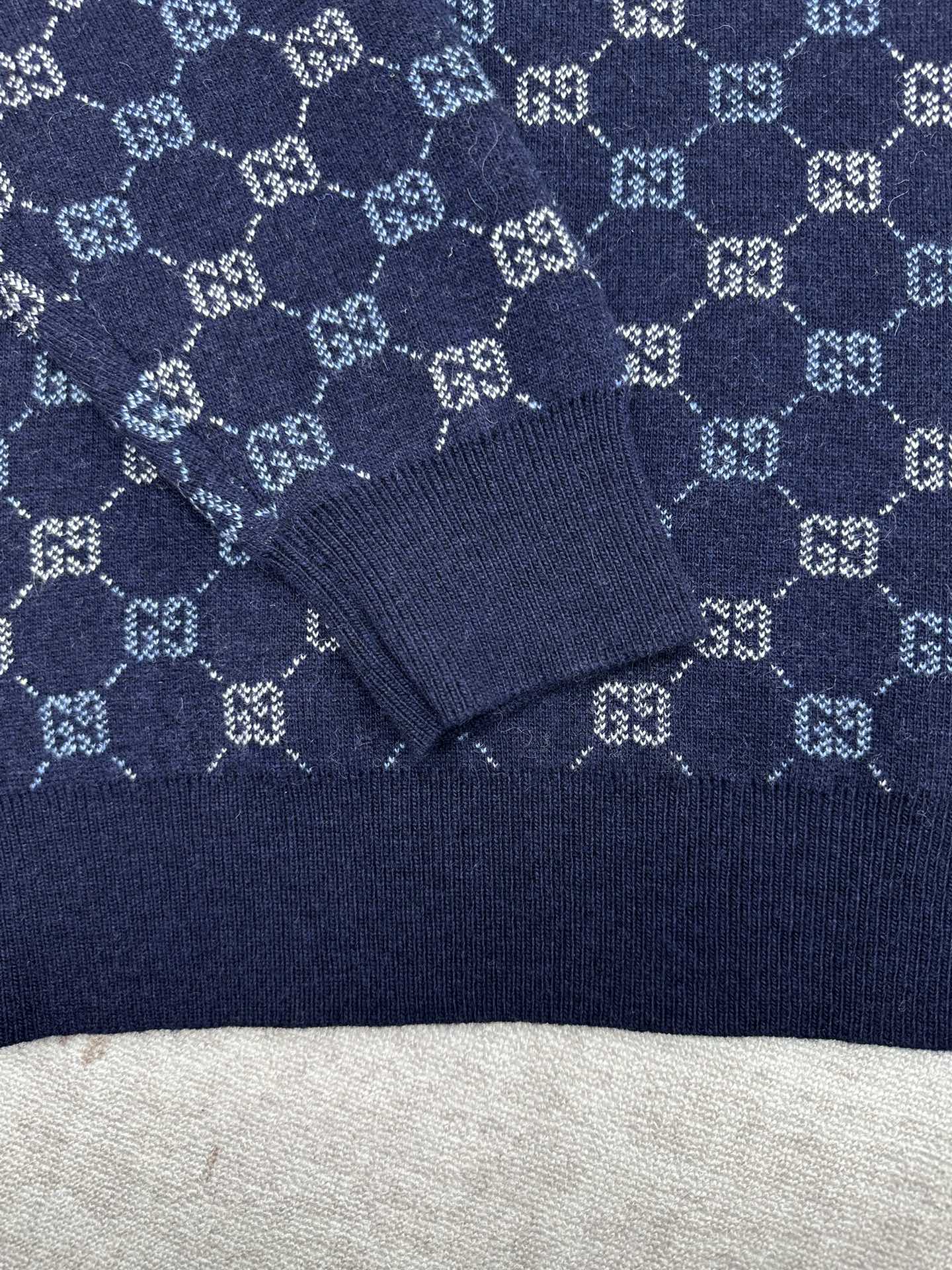 Navy long-sleeve sweater with GG monogram knit pattern and ribbed collar