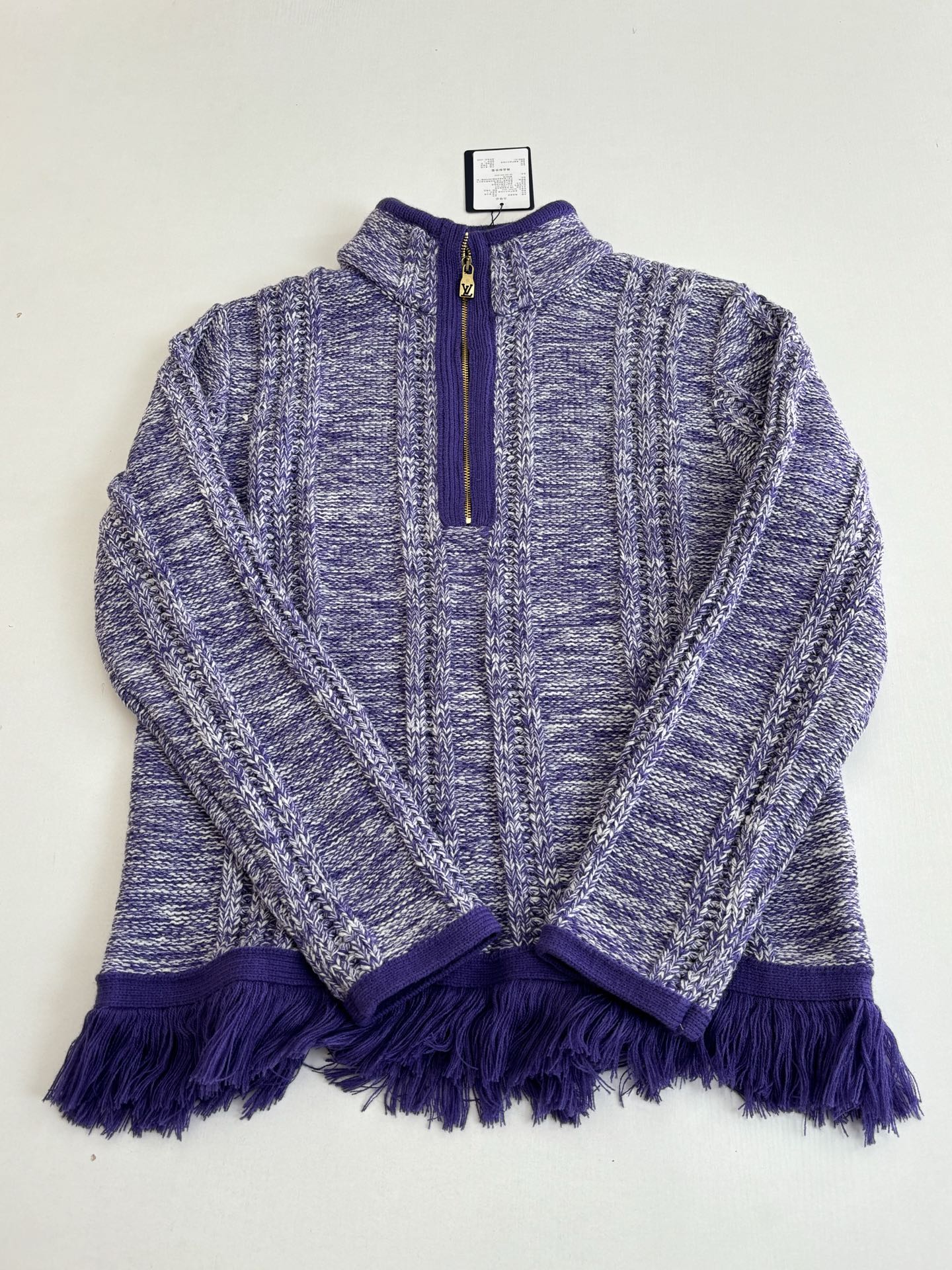Knit quarter-zip sweater with deep purple zipper trim and heathered blue textured body