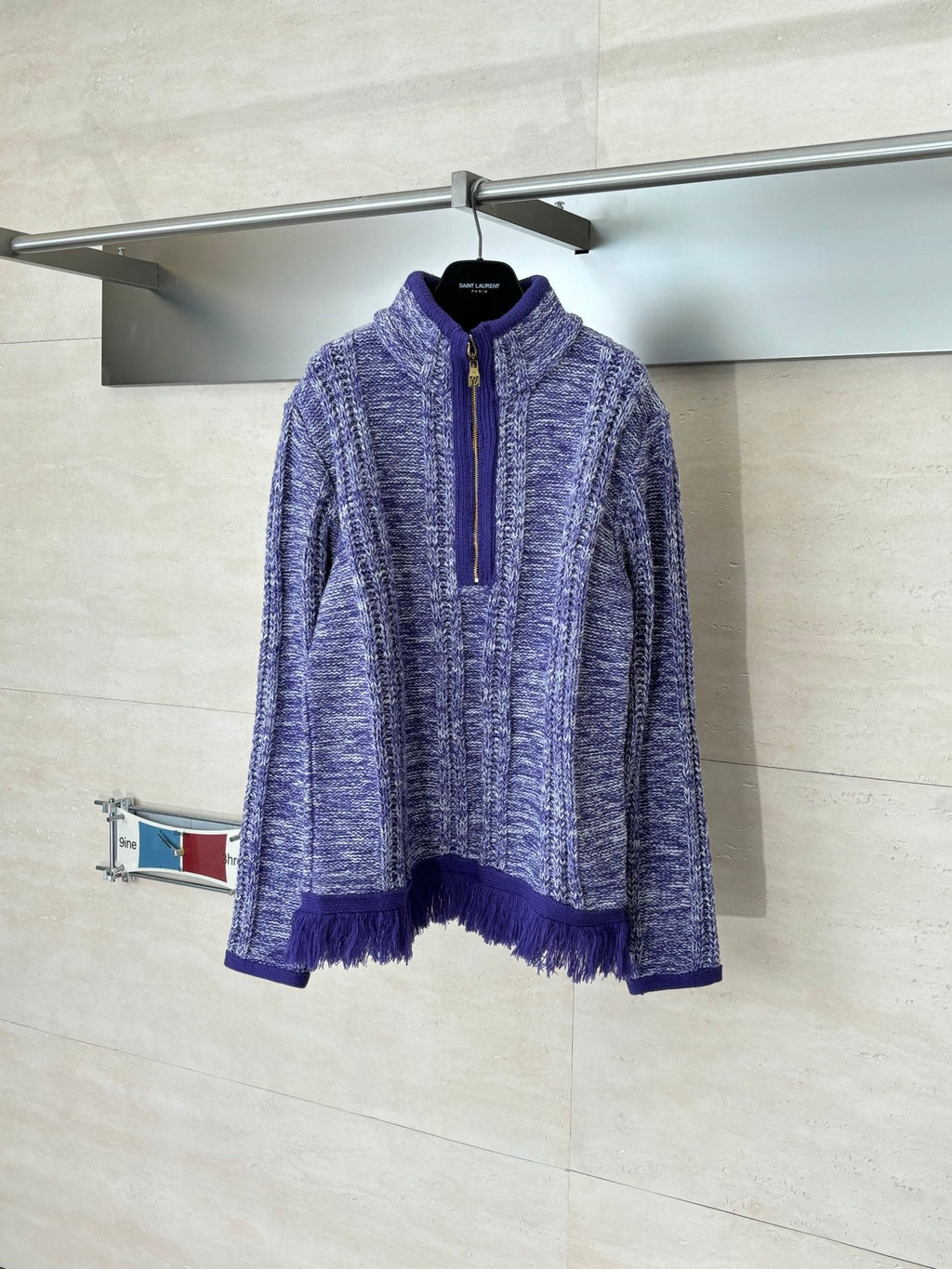 Long-sleeve knit quarter-zip sweater in heathered blue with purple fringe hem and cuffs