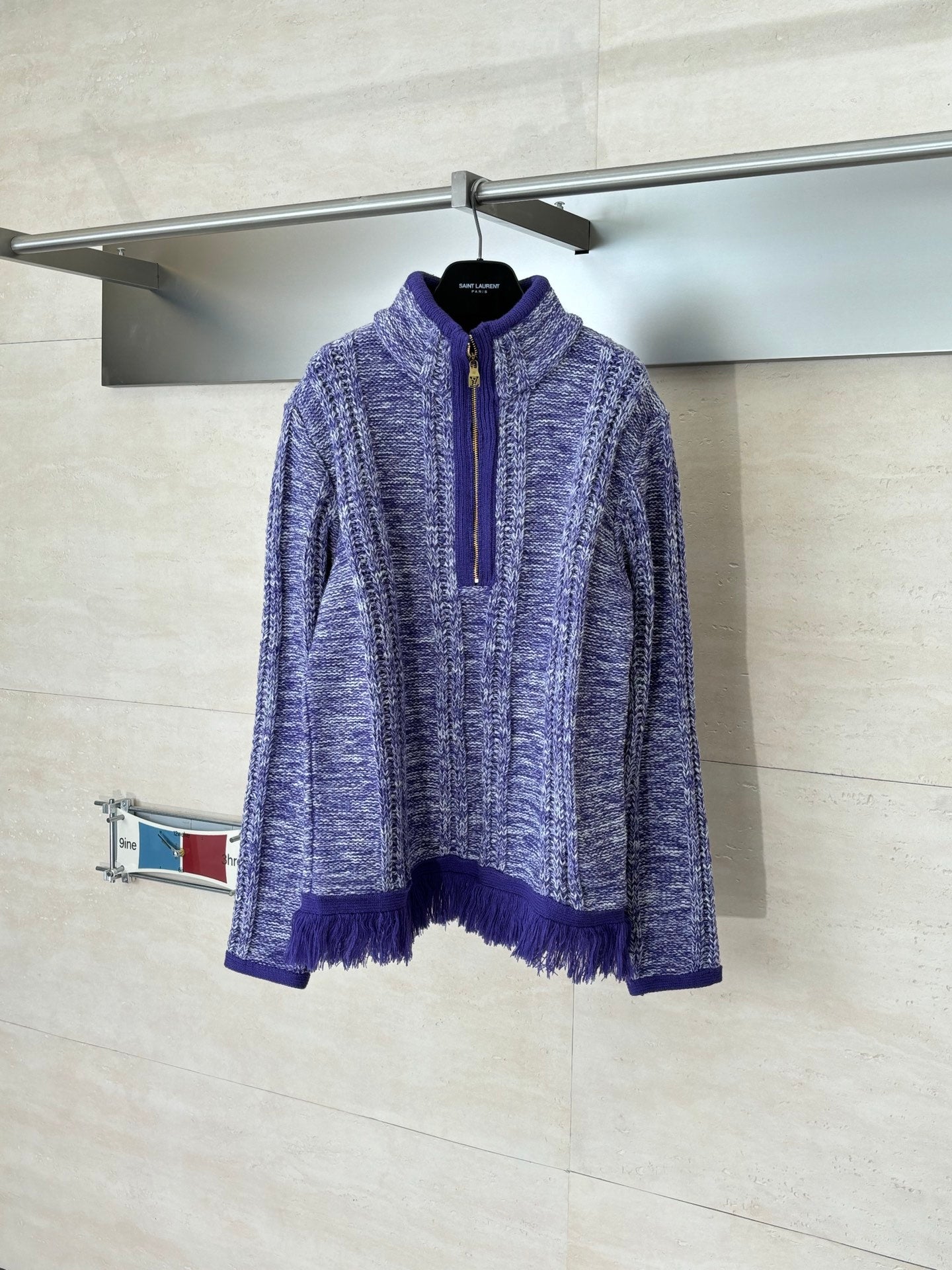 Long-sleeve knit quarter-zip sweater in heathered blue with purple fringe hem and cuffs