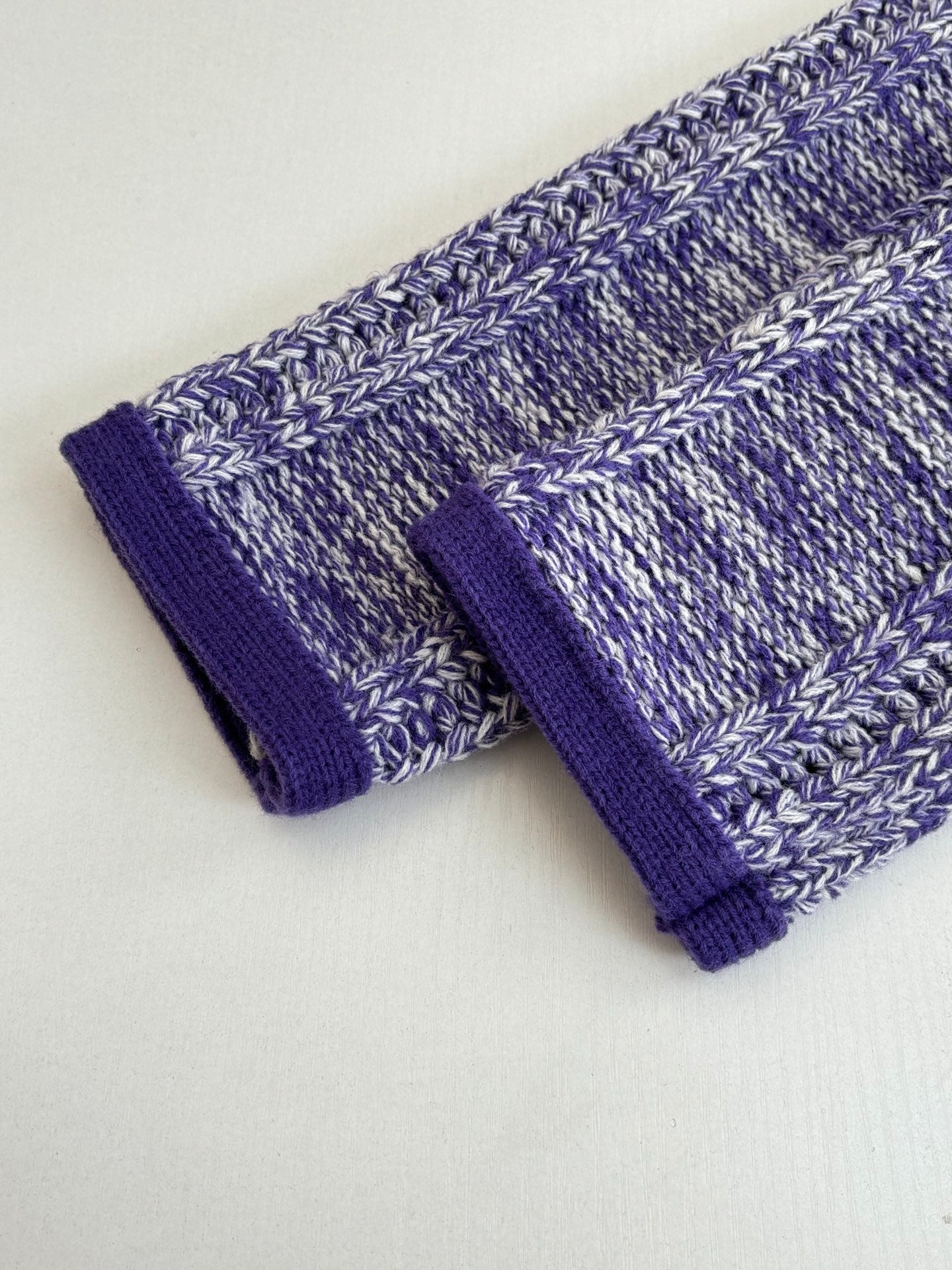 Ribbed knit cuffs with heathered blue body and deep purple cuff trim