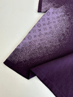 Purple T-shirt sleeve and side seam with monogram-style print