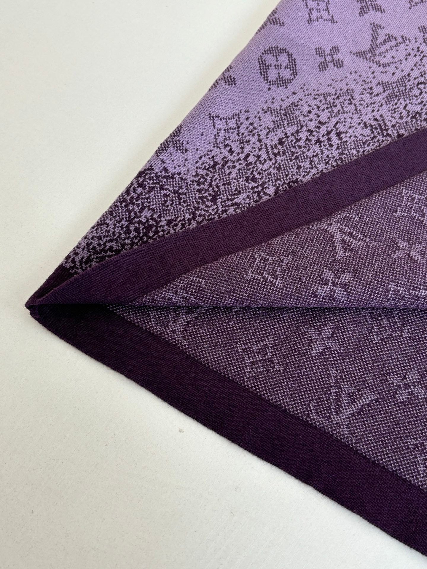 Purple T-shirt fabric and seam detail near hem