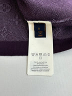 Inside care label on a purple T-shirt with wash and symbol instructions