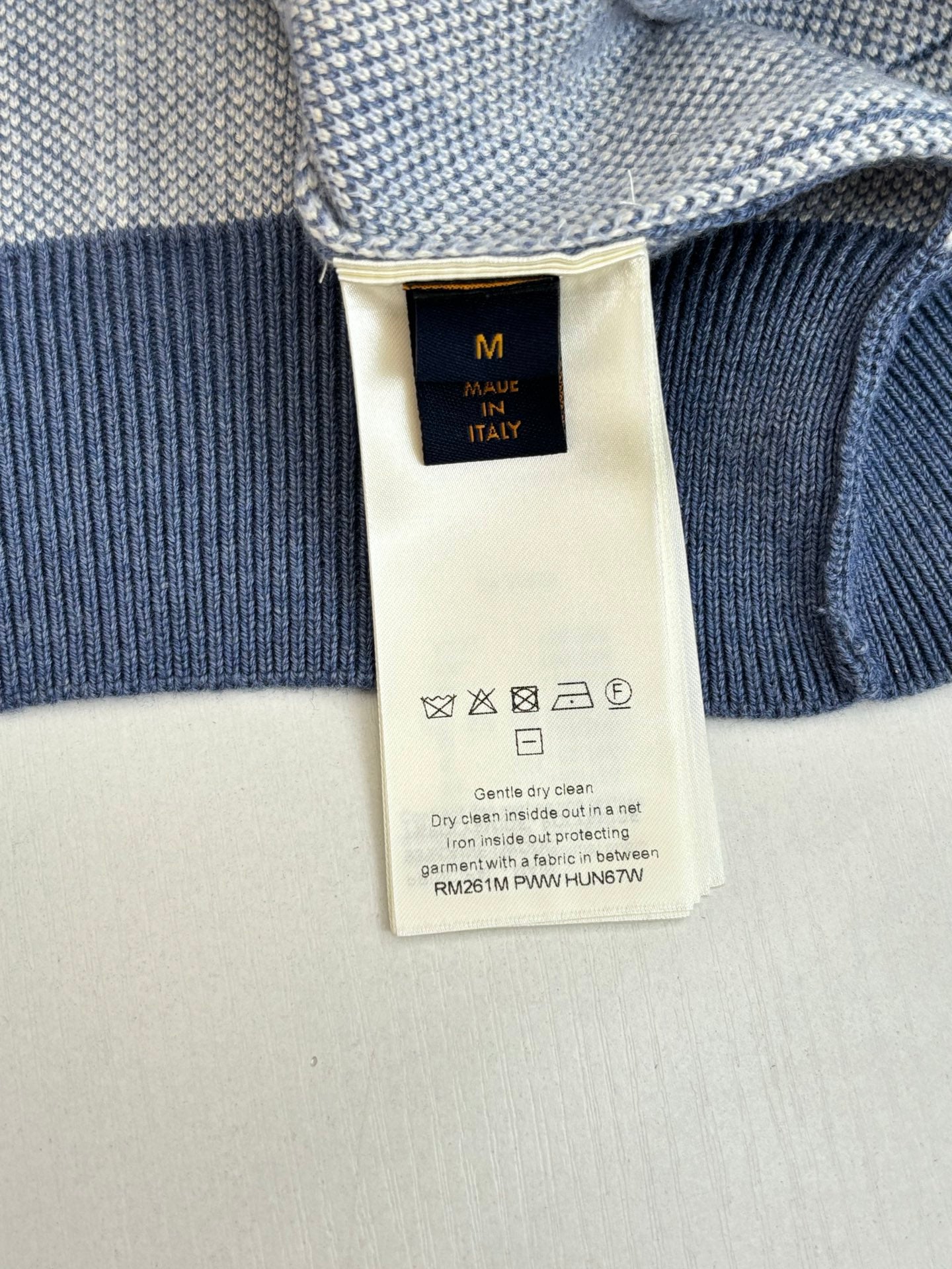 Ribbed knit long-sleeve top with size label and care icons