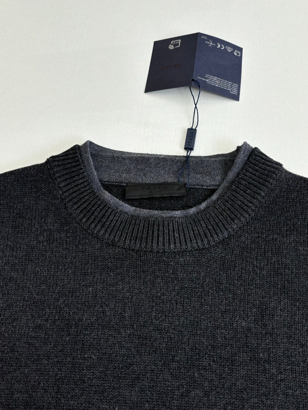 Dark knit crew-neck sweater with ribbed neckline and collar texture