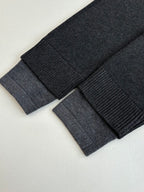 Dark knit sweater cuff and sleeve ribbing close-up
