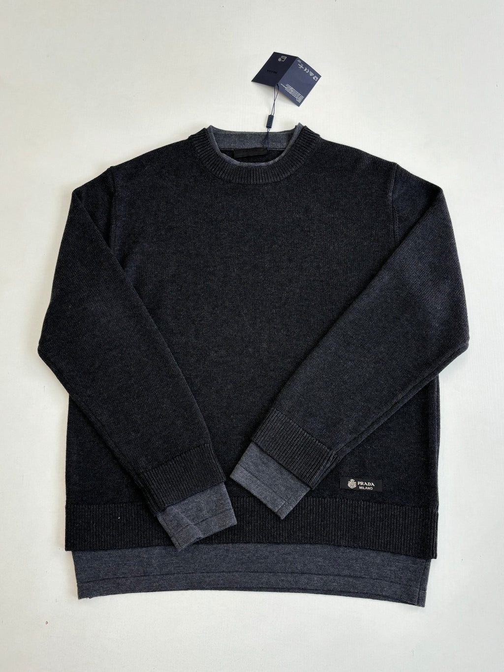 Dark knit crew-neck long-sleeve sweater with ribbed hem and cuffs