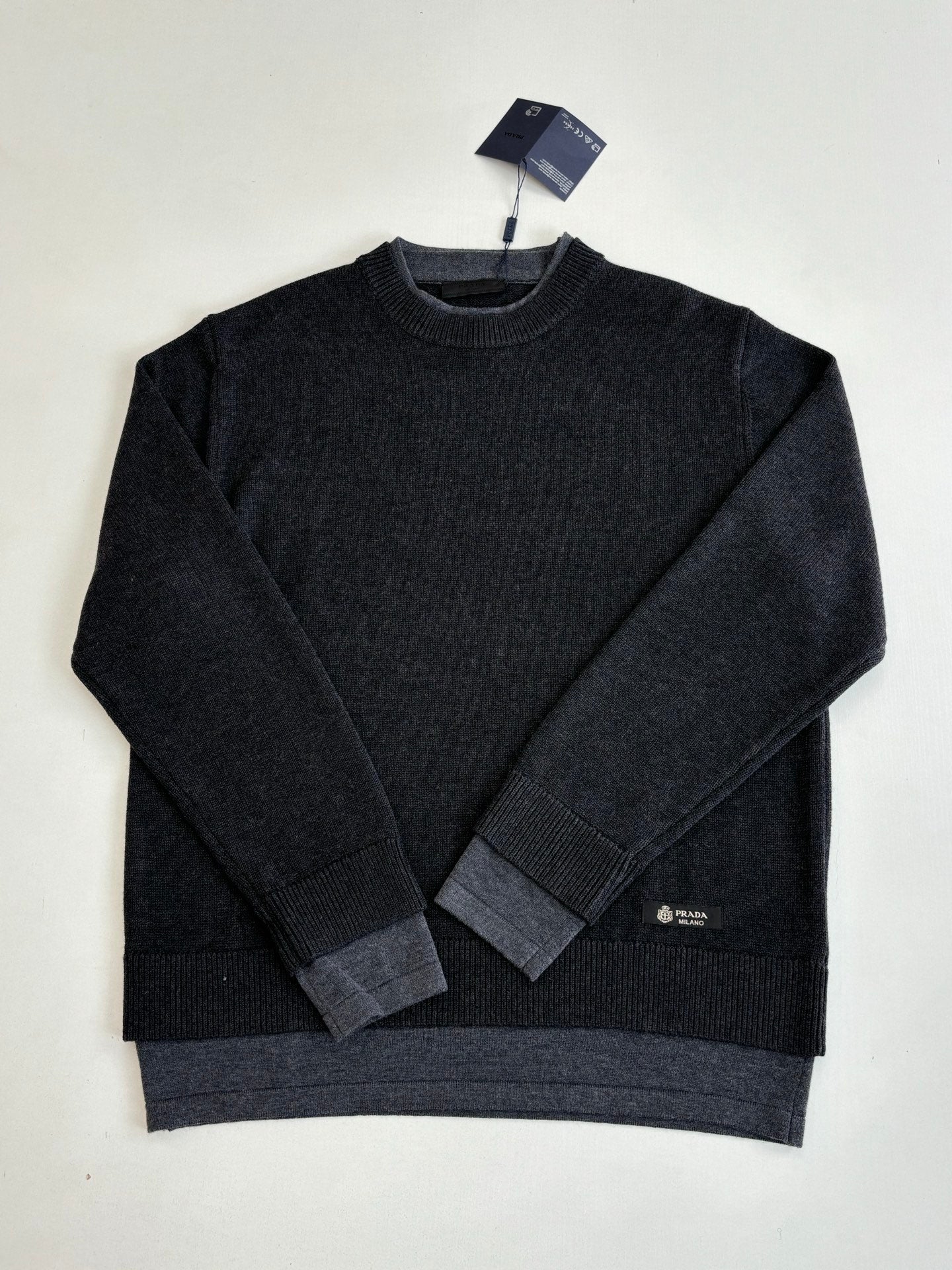 Dark knit crew-neck long-sleeve sweater with ribbed hem and cuffs