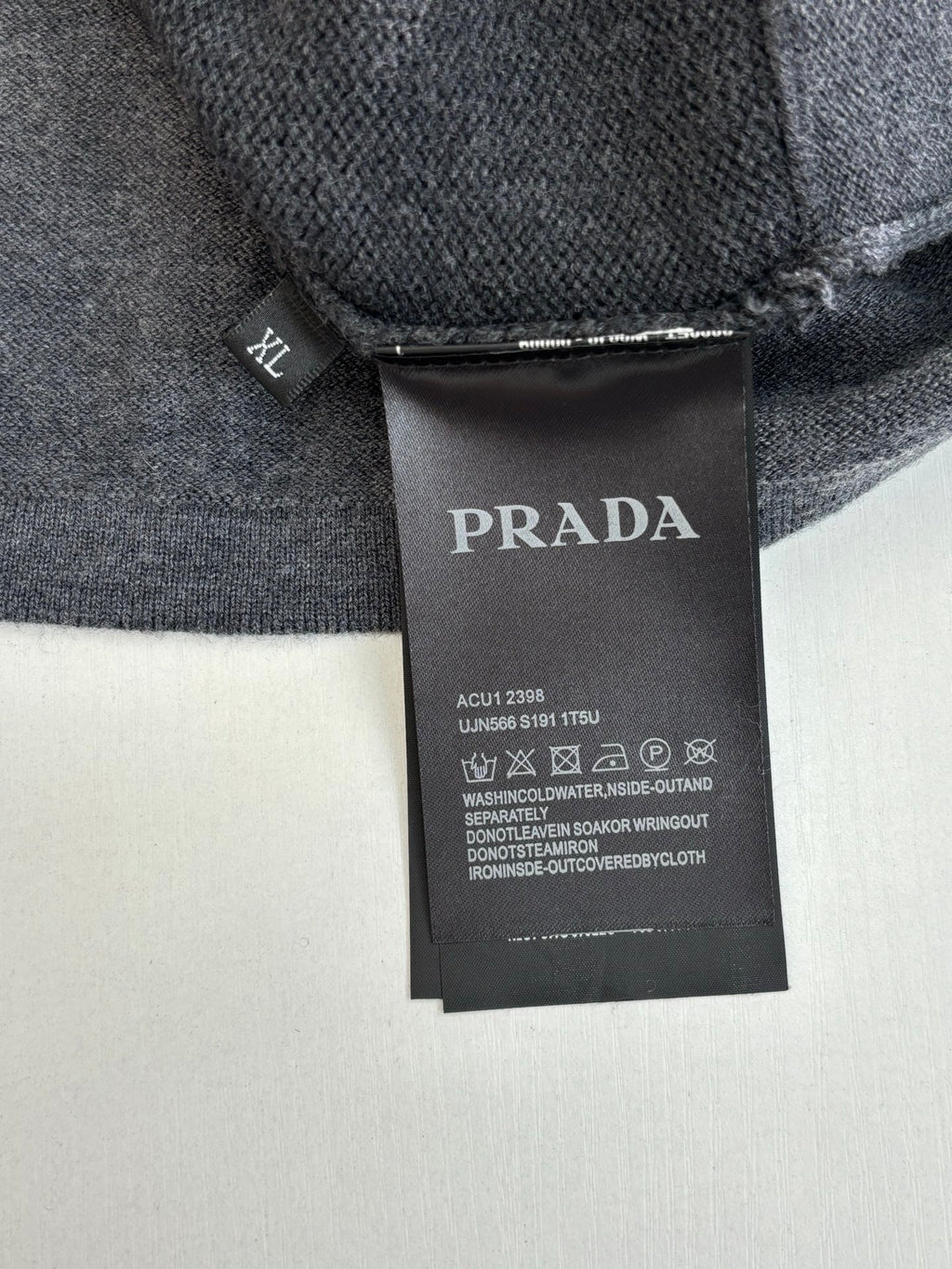 Prada size and care label on gray knit sweater tag