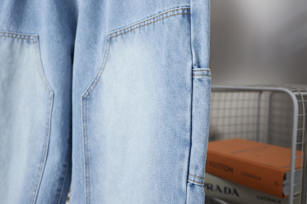 Light blue denim pants with side patch pocket and stitched hem