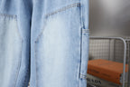 Light blue denim pants with side patch pocket and stitched hem