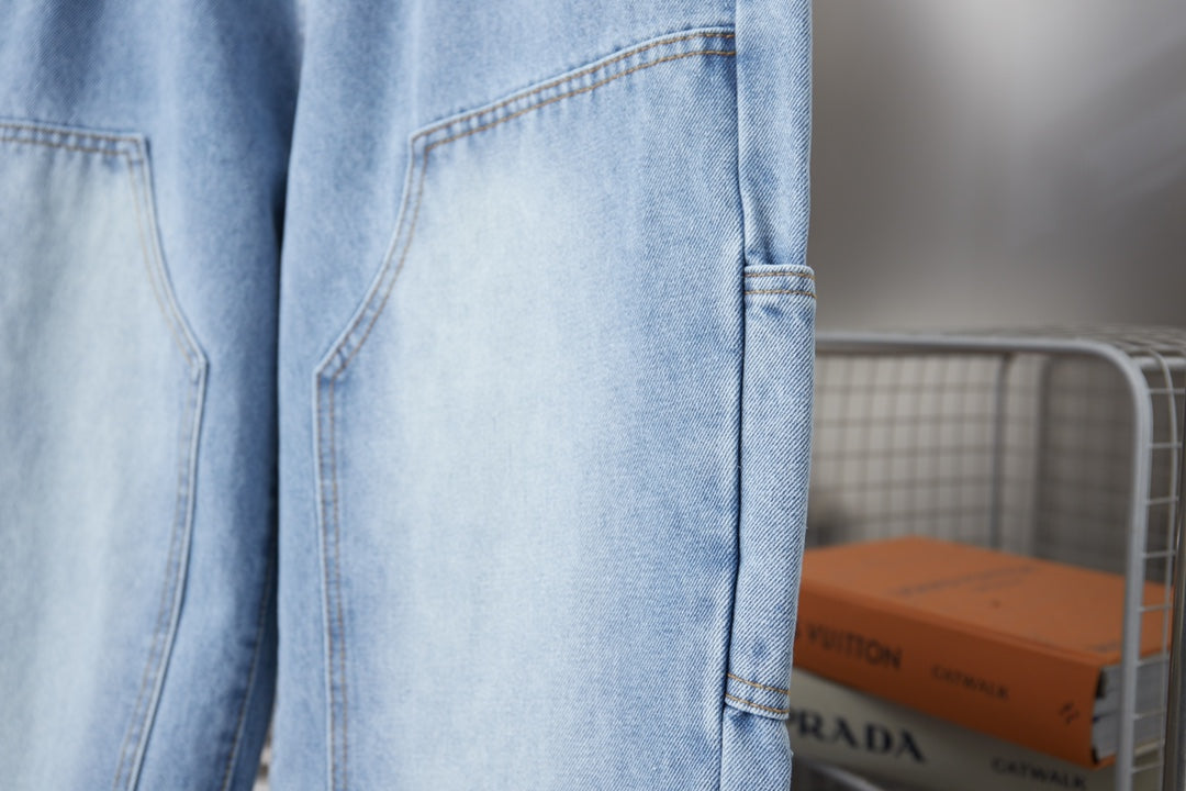 Light blue denim pants with side patch pocket and stitched hem