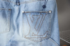 Light blue denim pants close-up of embroidered back pocket
