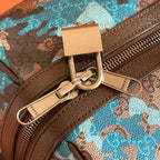 Duffel bag close-up of metal clasp, zipper pull, and brown leather trim