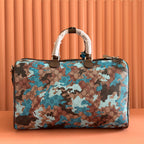 Camouflage-print duffel bag with top handles, brown zipper, and matching strap
