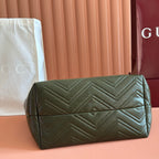 Olive green quilted leather clutch-style bag with zipper top