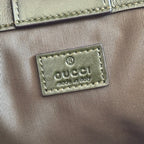 Green fabric Gucci logo patch reading "GUCCI" and "made in Italy"
