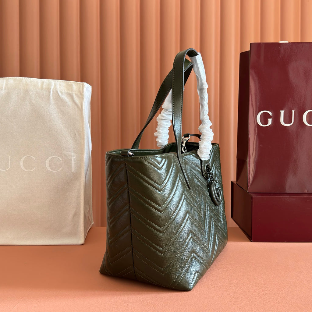 Olive green quilted leather shoulder tote bag with hanging strap and pouch