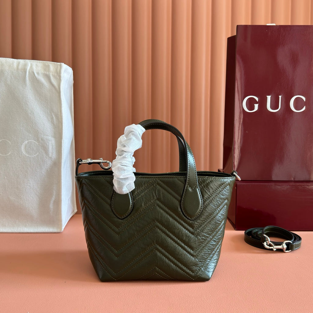 Dark green quilted leather handbag with rounded handles and silver-tone metal hardware