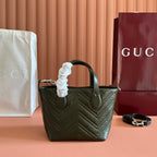 Dark green quilted leather handbag with rounded handles and silver-tone metal hardware