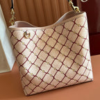 Gucci bag front view in cream with red lattice pattern, gold-tone hardware, rounded base.