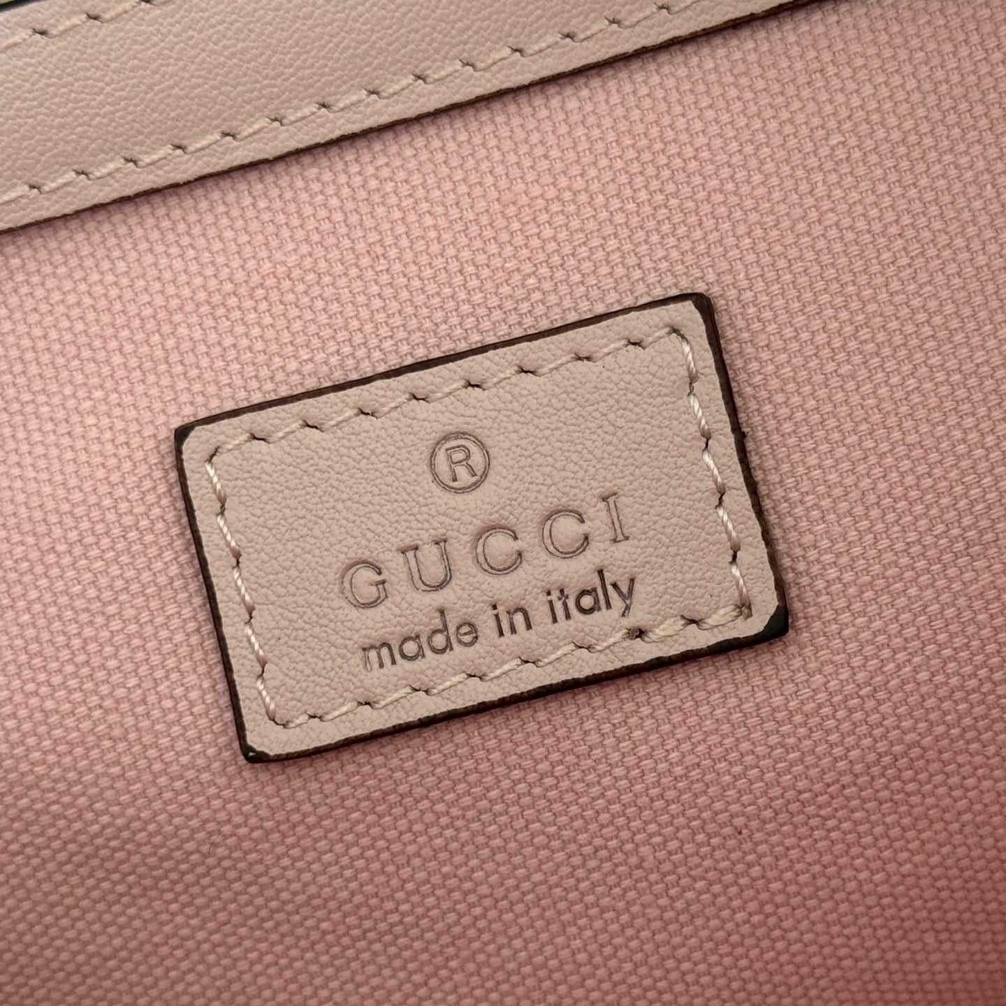 Gucci made in Italy label patch on pink interior lining, stitched border.
