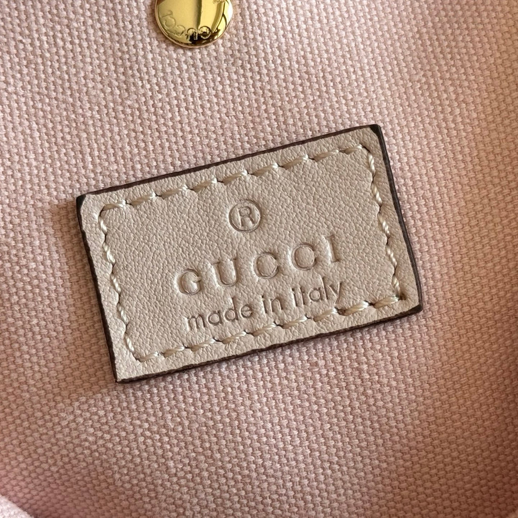 Gucci bag leather label with 'made in Italy' text on beige fabric