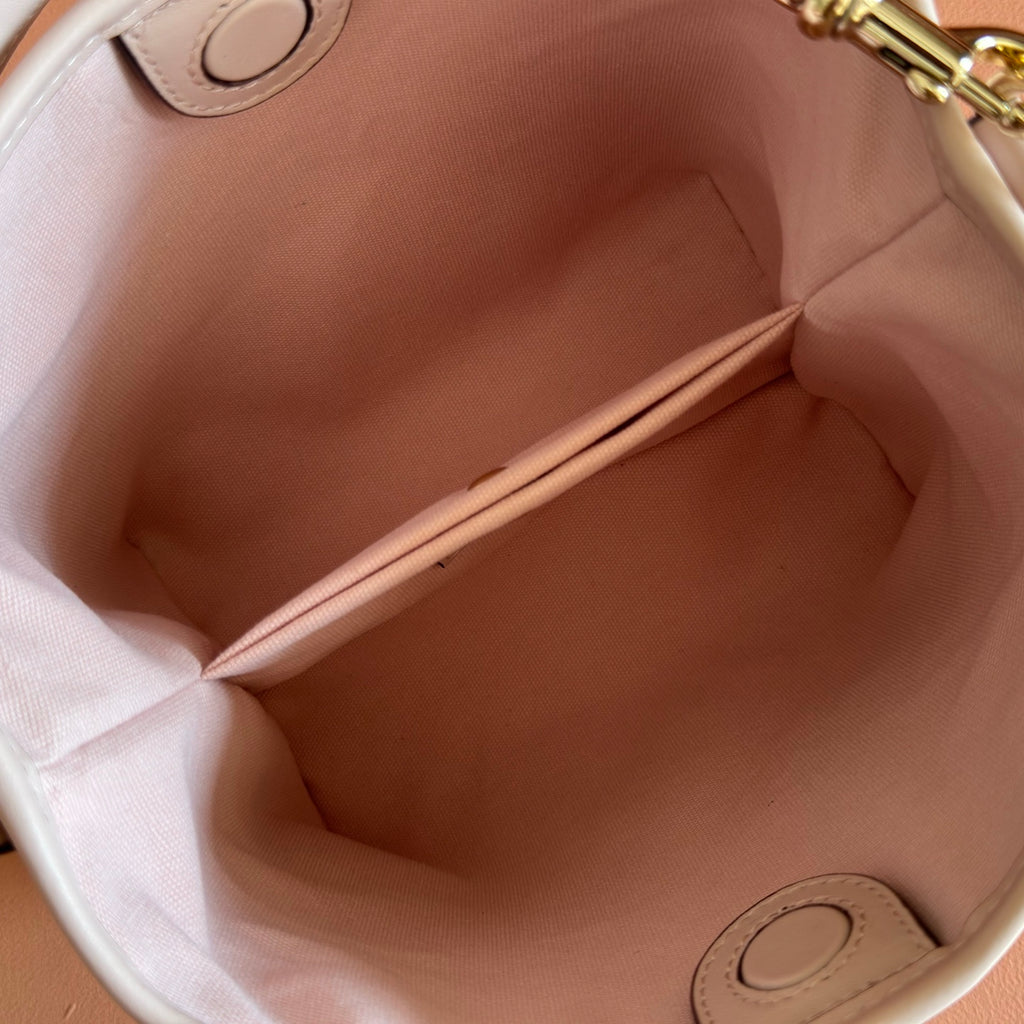 Gucci bag interior with light pink lining and stitched corner seams