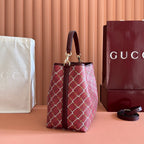 Gucci bag with burgundy lattice print, side panels and top handles
