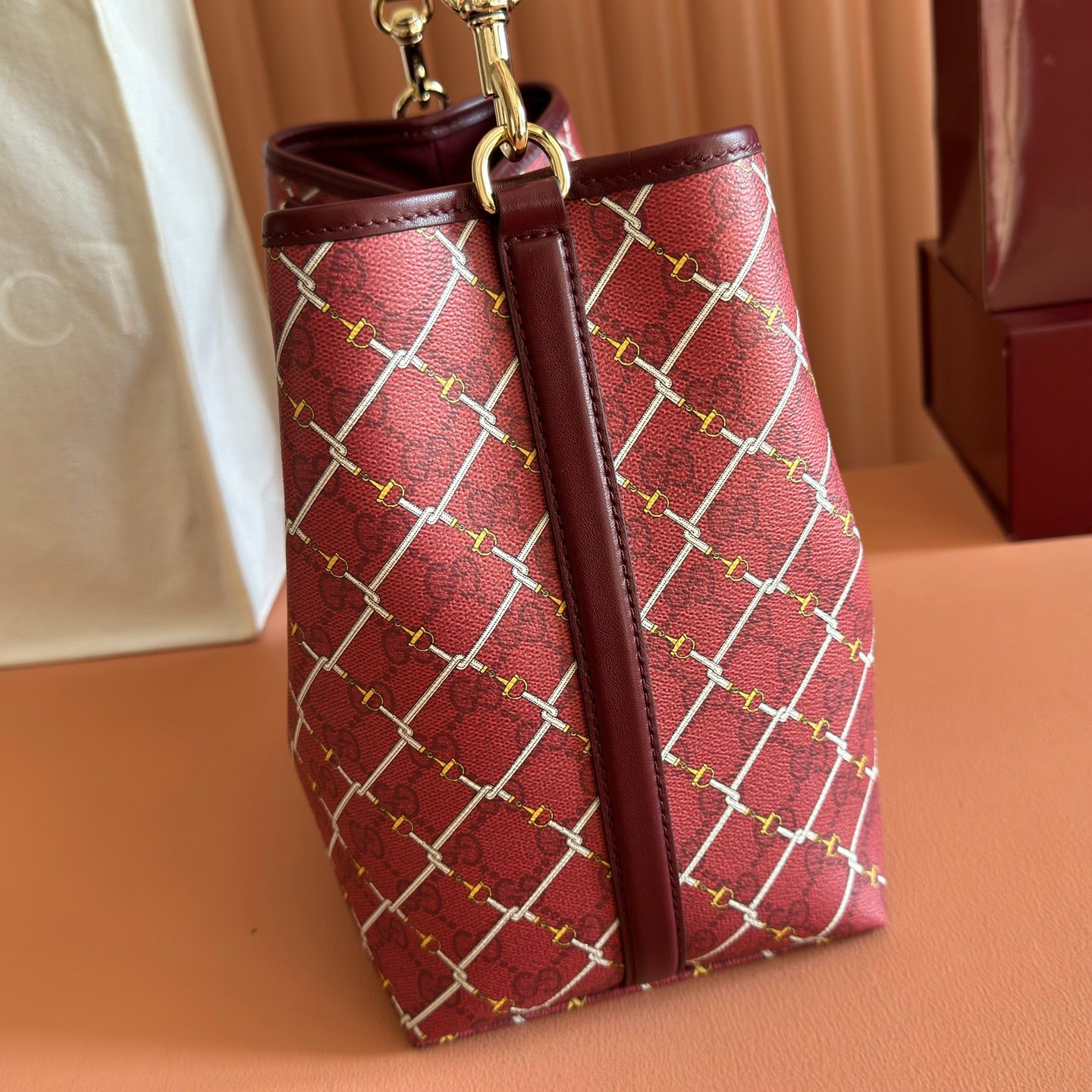 Gucci bag with burgundy lattice print, front seam and top handles