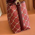 Gucci bag side view burgundy with vertical strap panel and gold ring pull