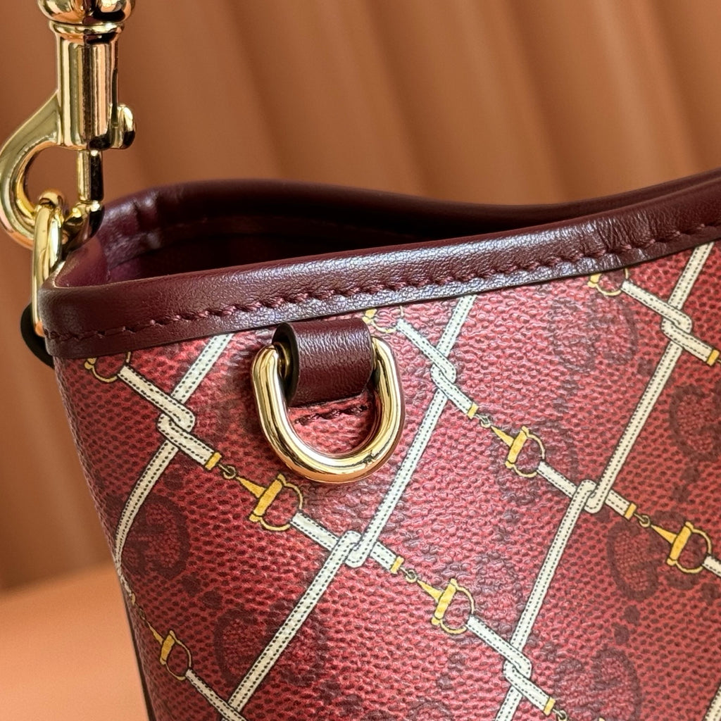 Gucci bag side close-up with burgundy leather trim and gold hardware ring