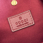 Gucci bag label patch reading Gucci and made in Italy on pink fabric