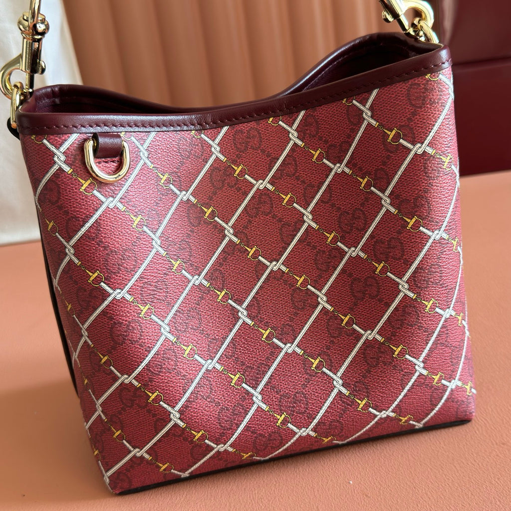 Gucci bag front view burgundy with interlocking lattice print and leather top trim