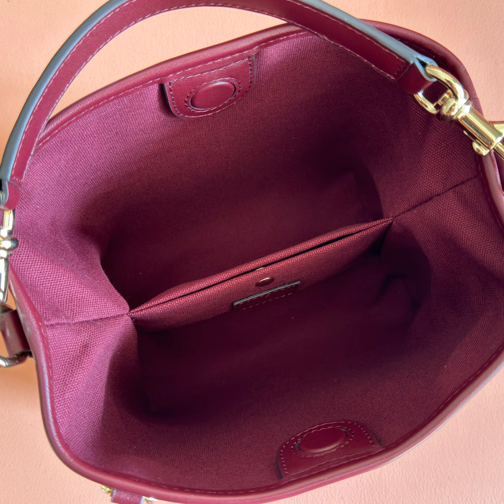 Gucci bag interior in burgundy with slip pocket and gold hardware ring