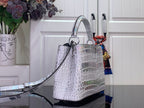 Louis Vuitton top-handle handbag with long strap, iridescent white croc-embossed leather