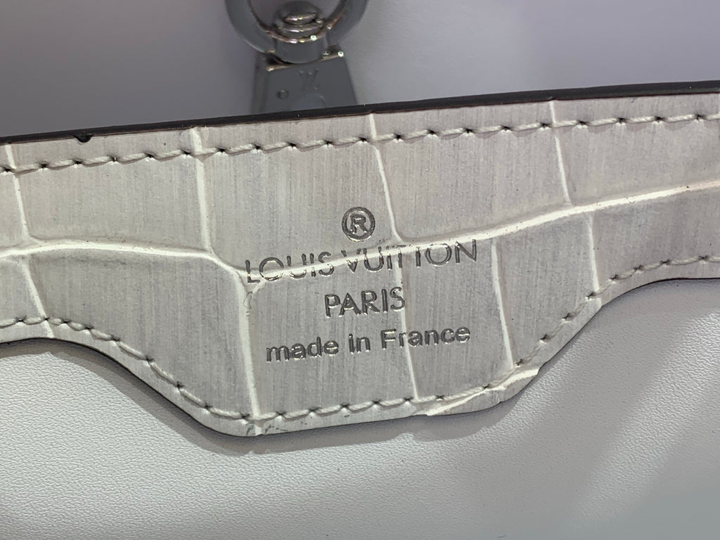 Louis Vuitton Paris made in France stamp on iridescent white leather near clasp