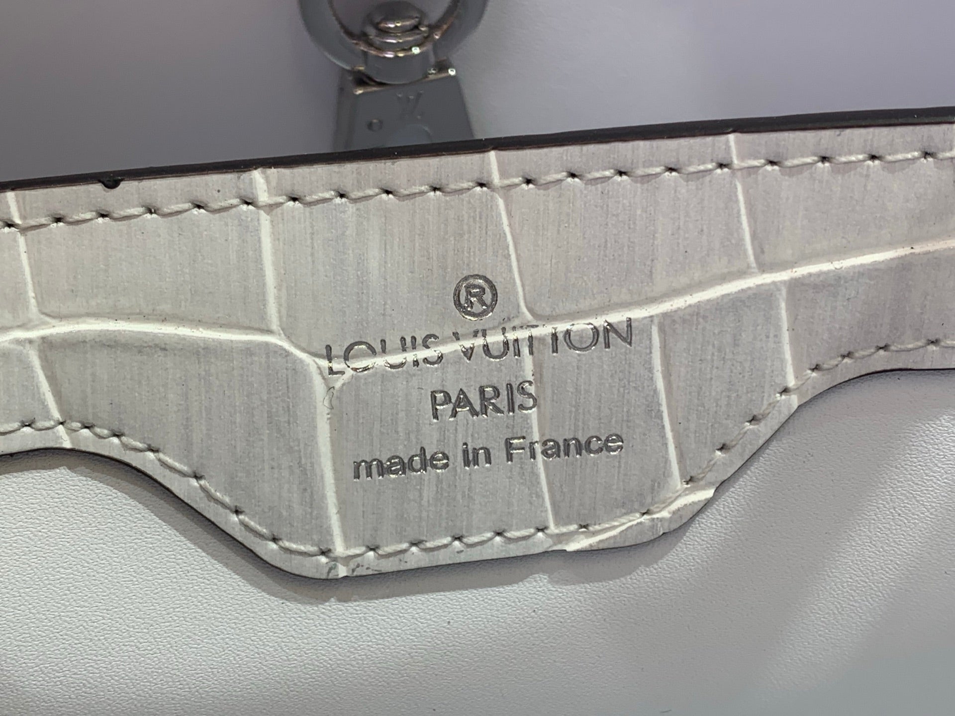 Louis Vuitton Paris made in France stamp on iridescent white leather near clasp